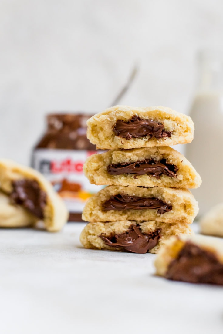 stacked nutella stuffed sugar cookies showing stuffed centers
