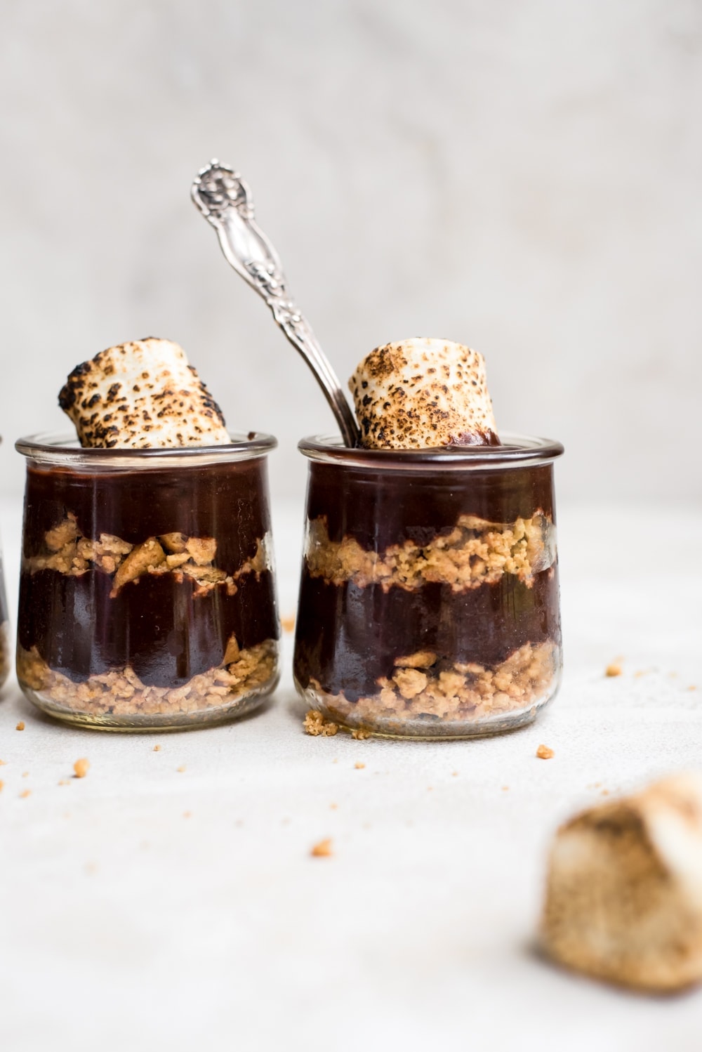 s'mores pudding in jars with a spoon