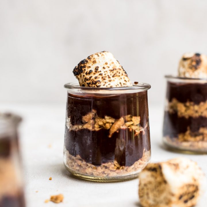 close up s'mores pudding in jar with toasted marshmallows