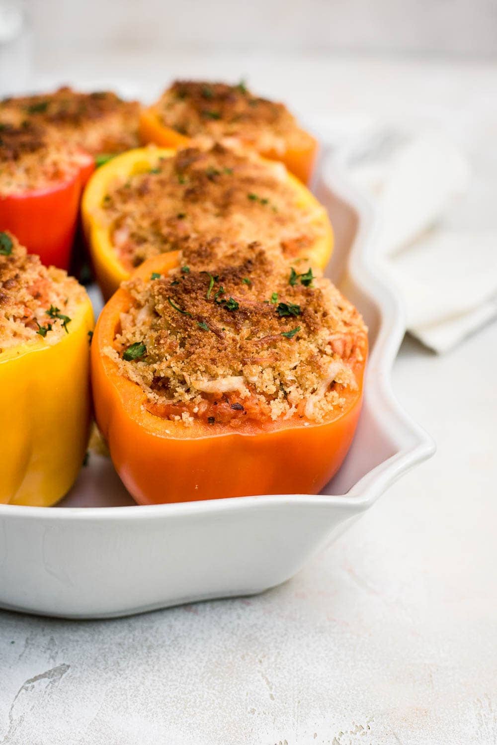 close up italian chicken stuffed peppers in baking pan