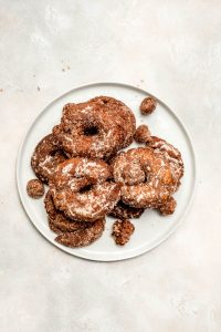 apple cider doughnuts on a white plate