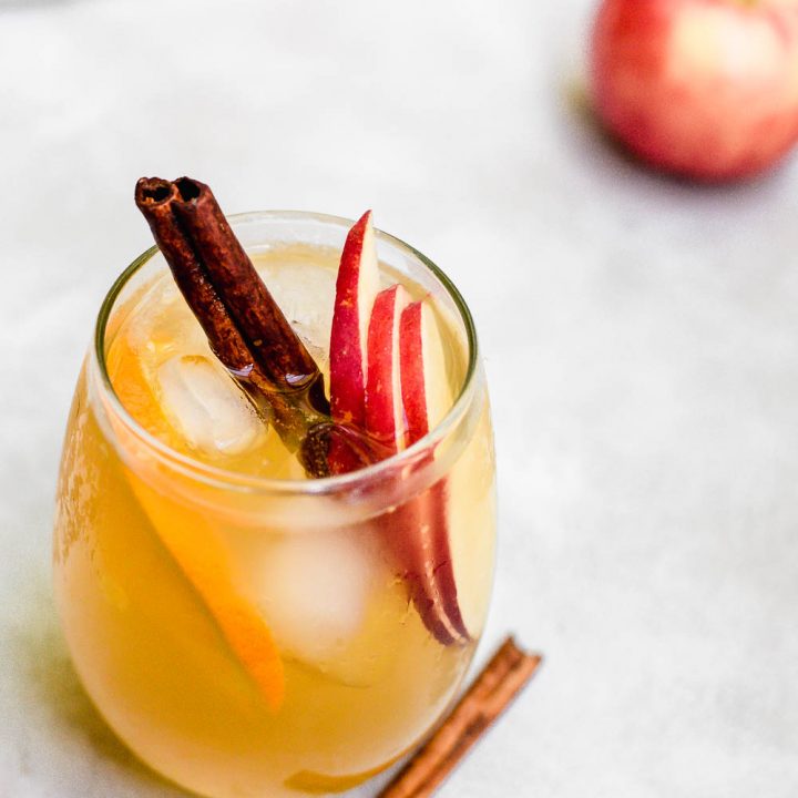 overhead apple cider sangria in glass with cinnamon garnish