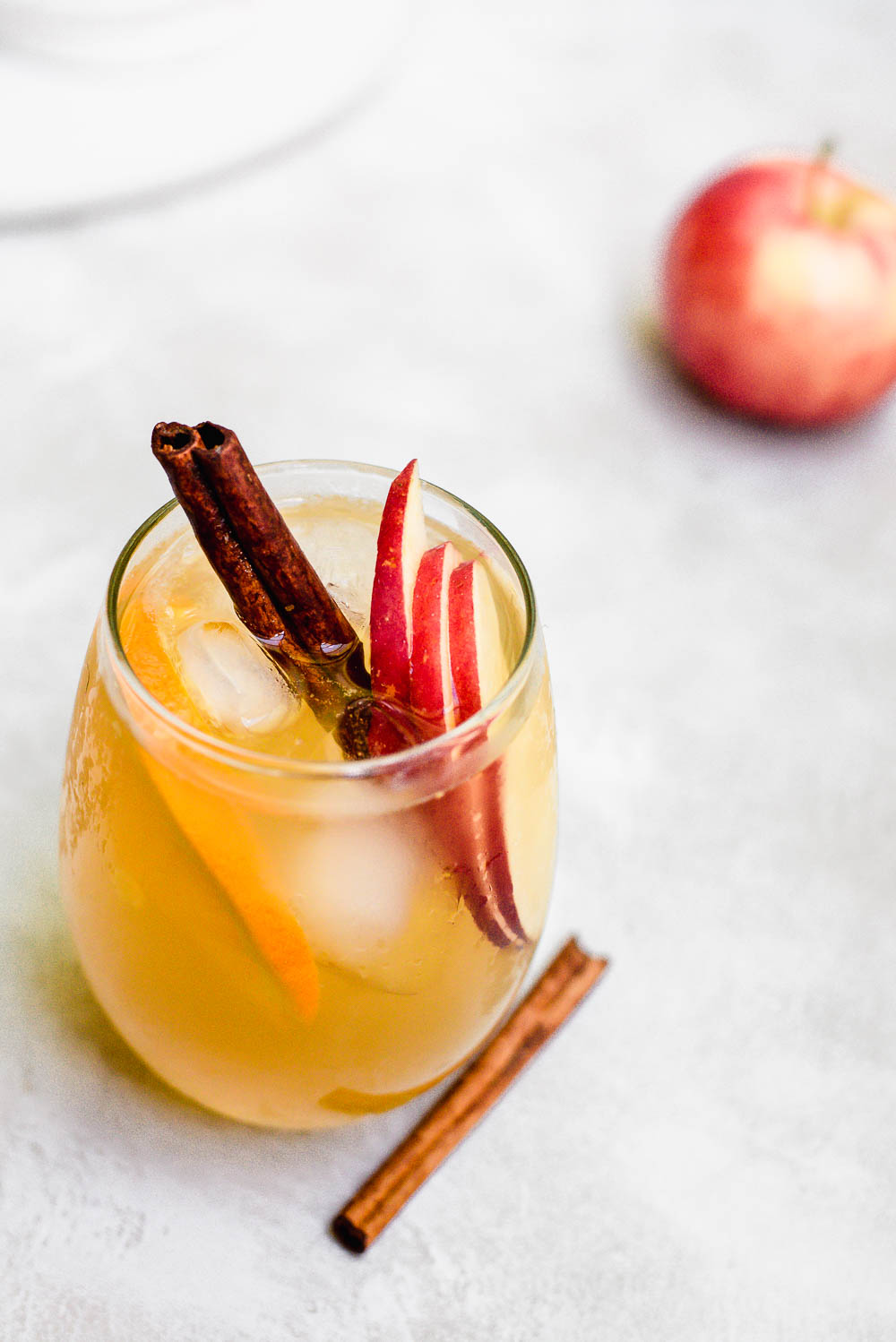 overhead apple cider sangria in glass with cinnamon garnish