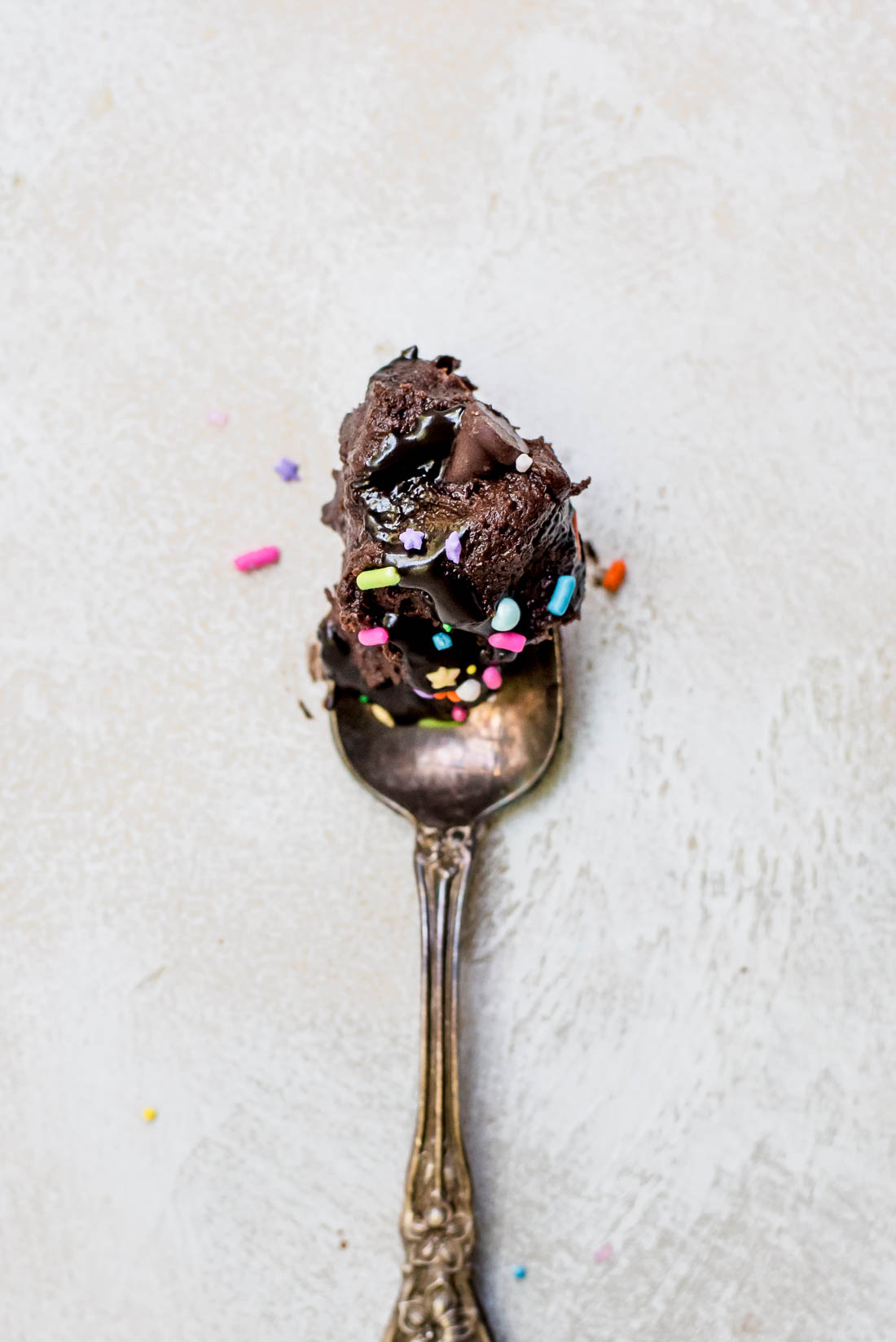 spoonful of batter with fudge and sprinkles