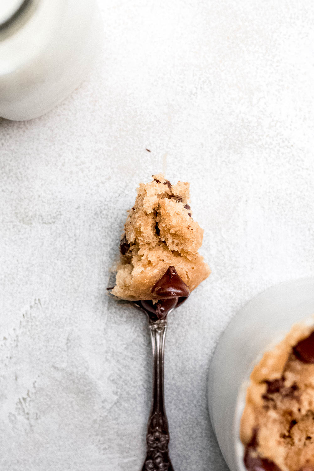 Spoonful of peanut butter mug cake with chocolate