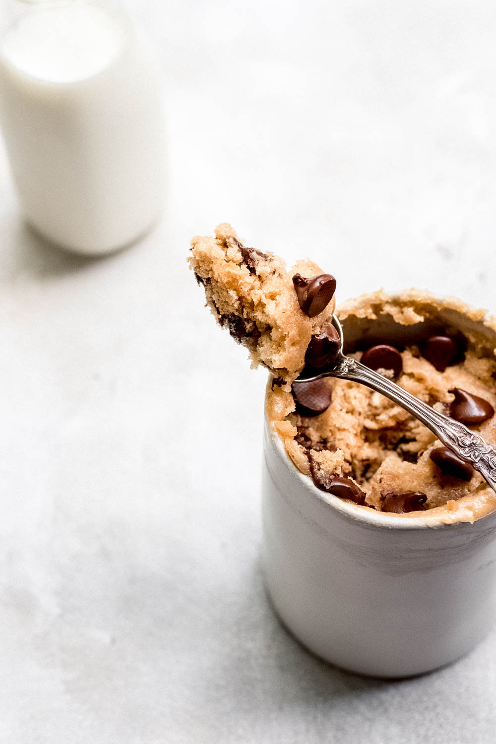 mug filled with peanut butter cake with spoonful of cake