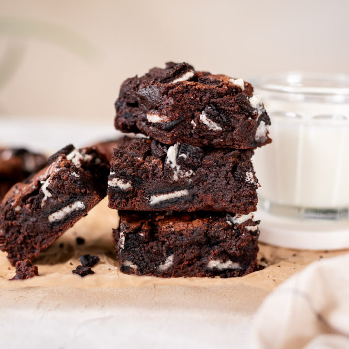 stacked brownies on parchment paper
