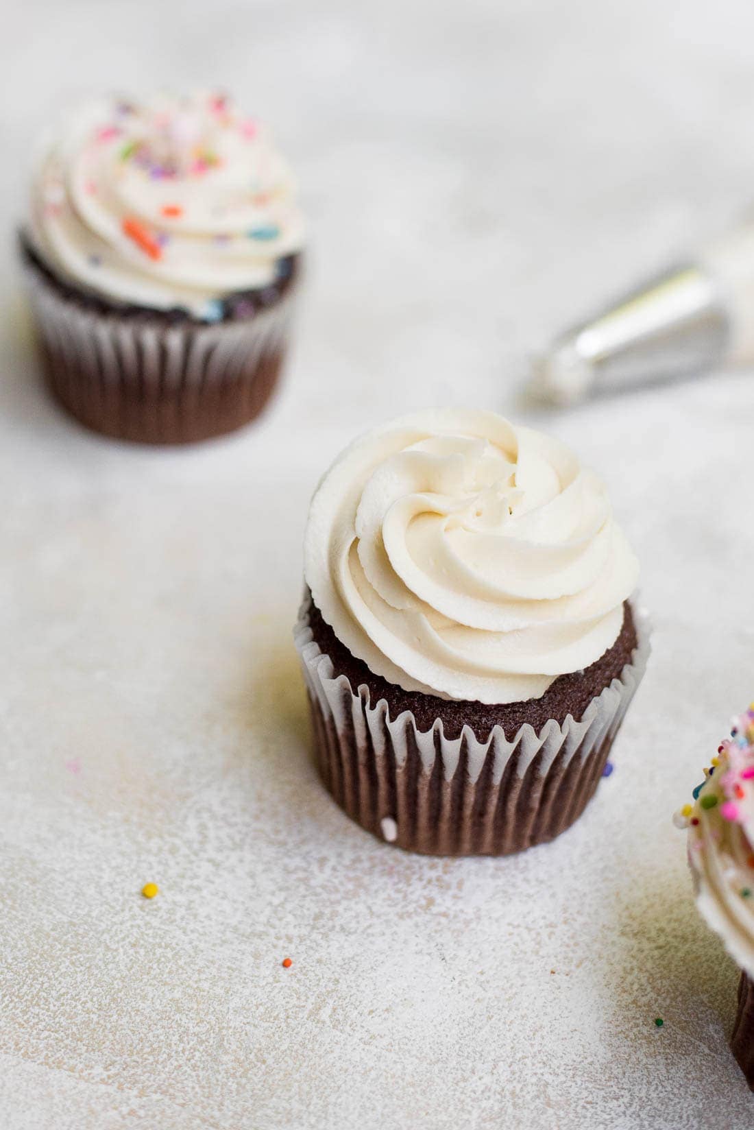 overhead of cupcakes topped with vanilla icing