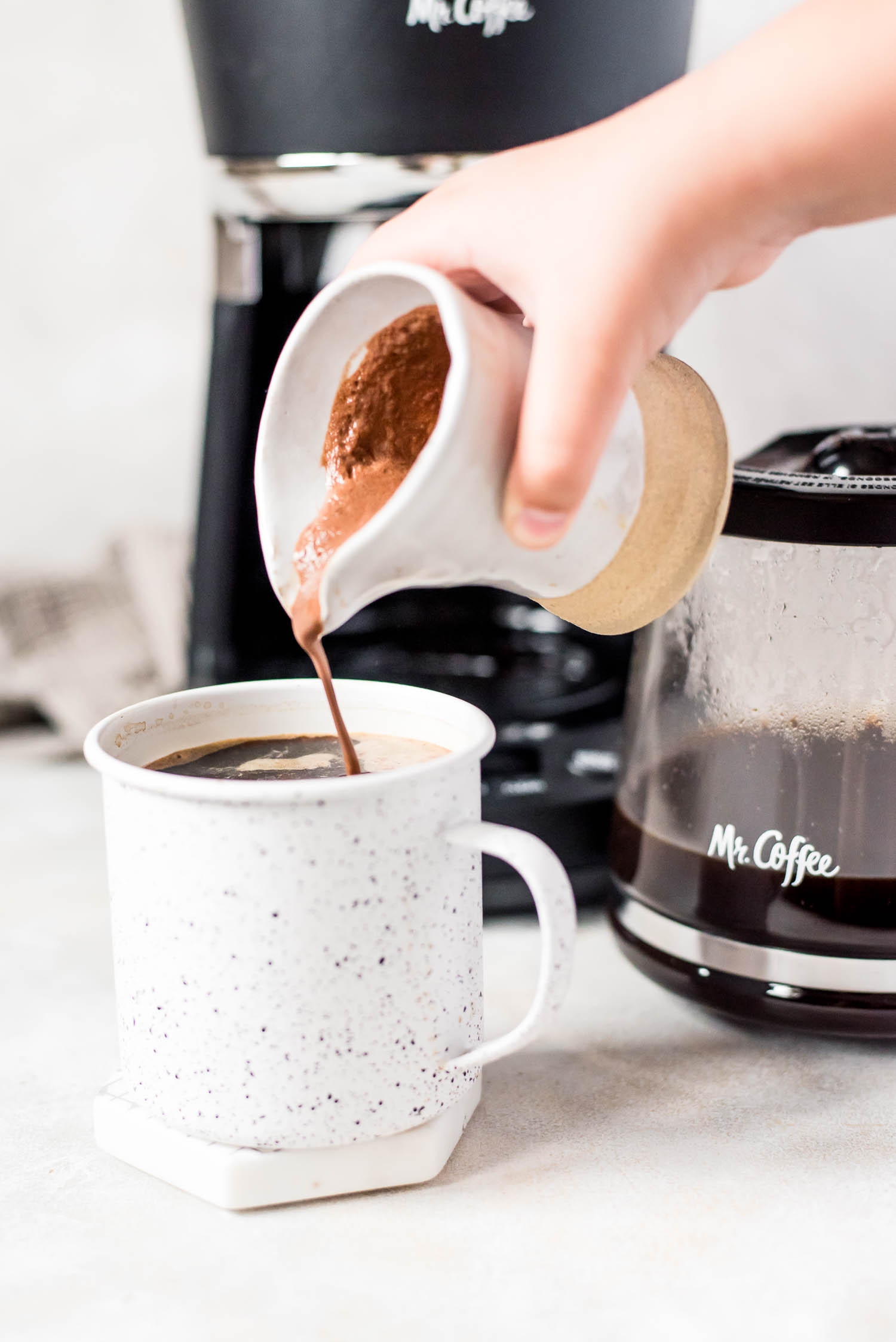 mocha coffee creamer poured into coffee mug