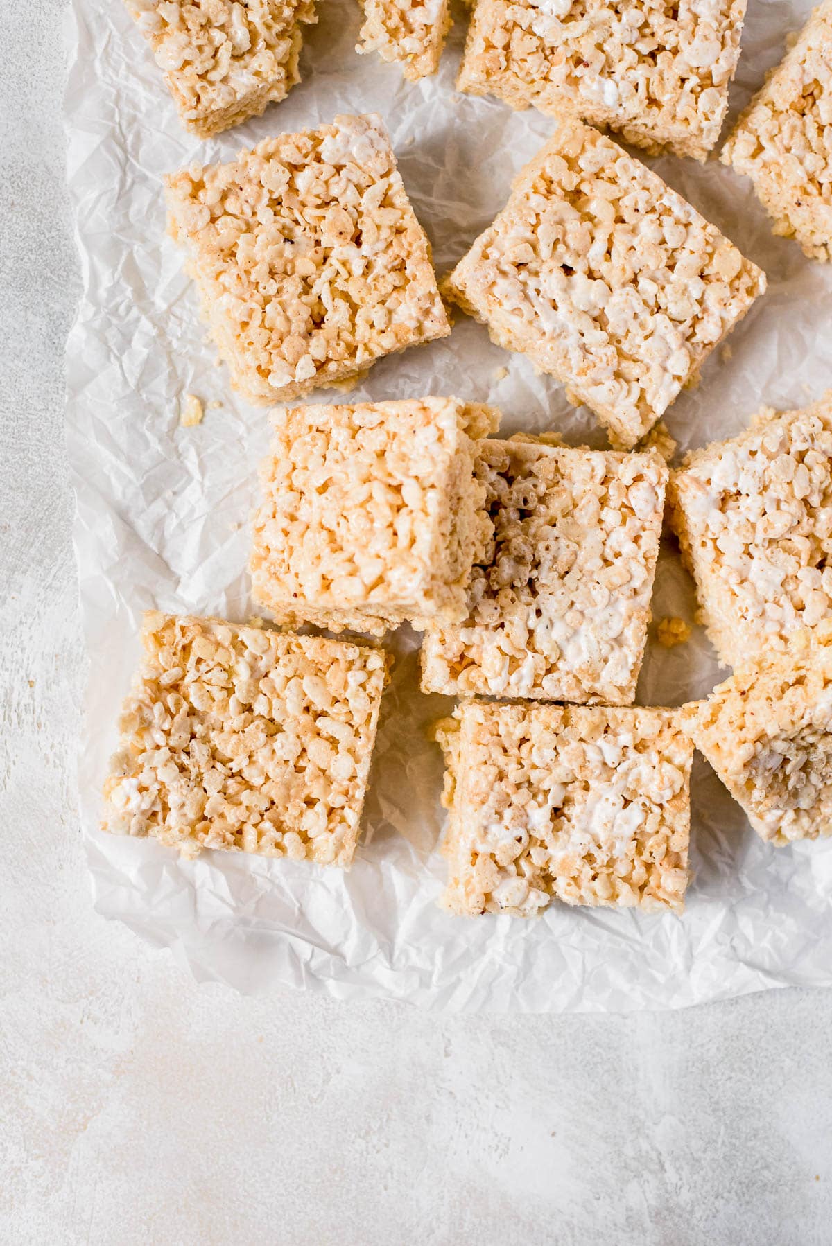 rice krispie treats scattered on parchment paper