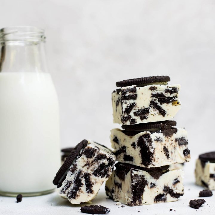 close up stack of oreo fudge next to milk jar