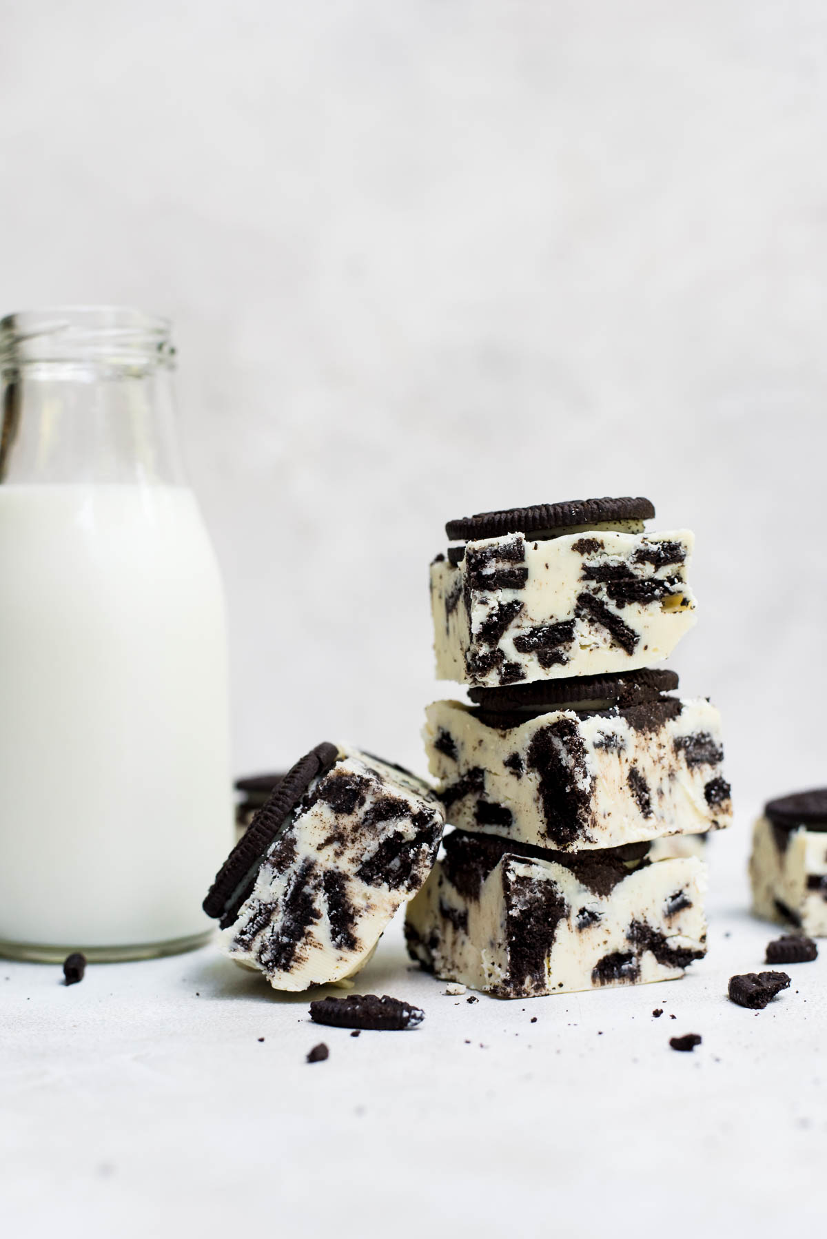 close up stack of oreo fudge next to milk jar