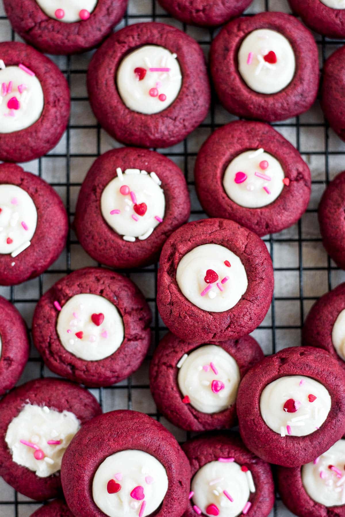 thumbprint cookies scattered on wire rack