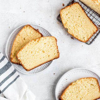 slices of vanilla pound cake on plates and being sliced