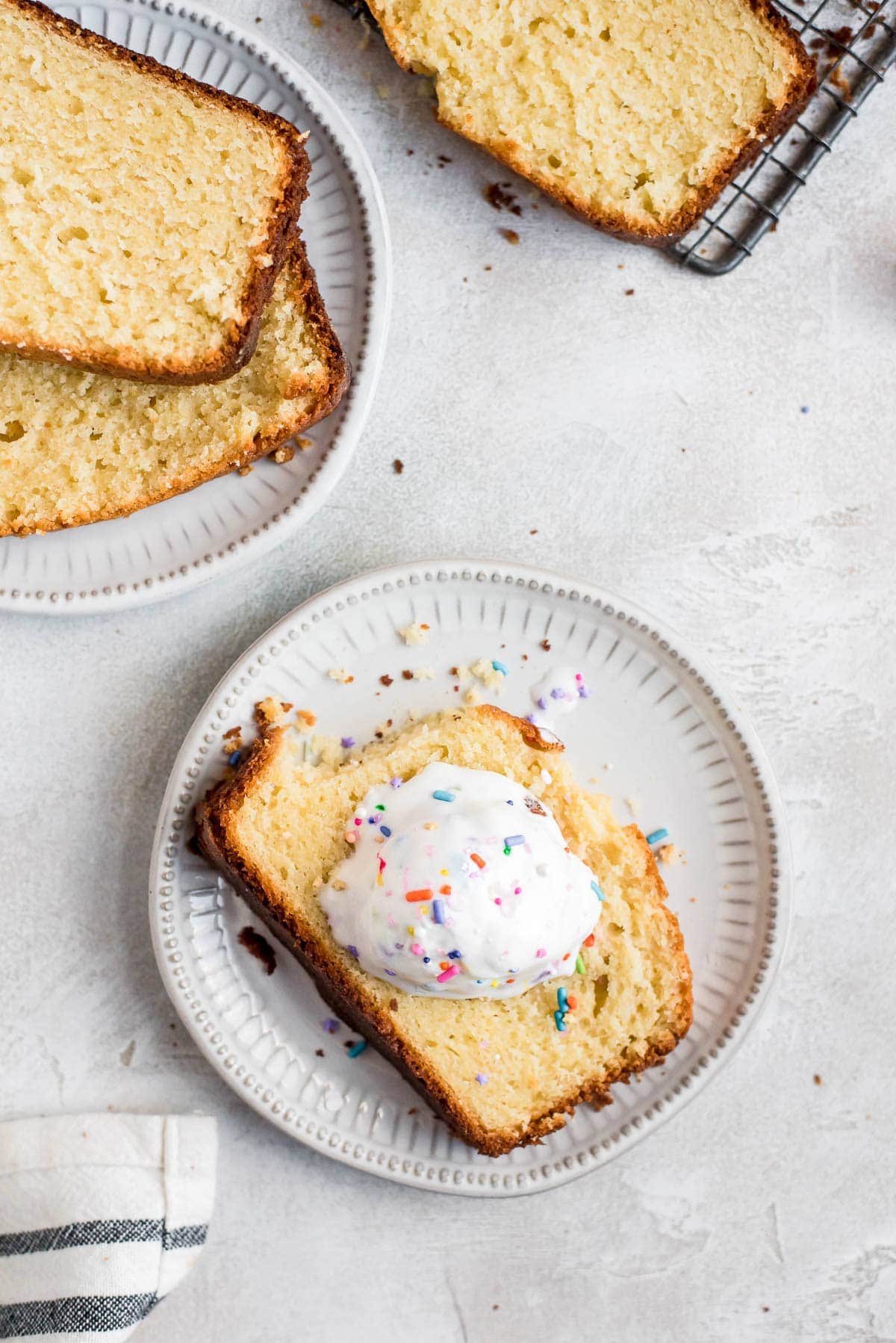 cake on plate with ice cream and sprinkles with piece missing