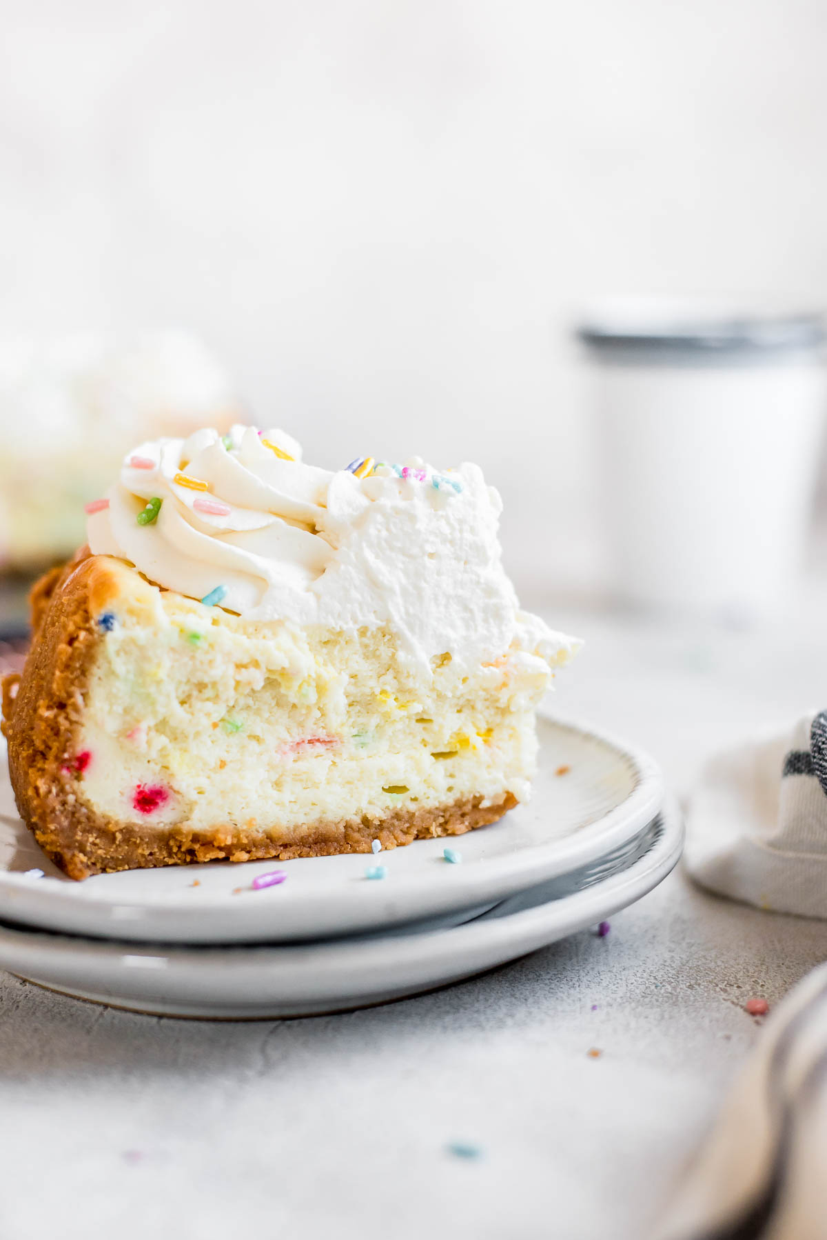 close up of slice of birthday cheesecake on plate