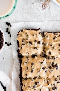 close up of piece of brownie slathered with cookie dough frosting