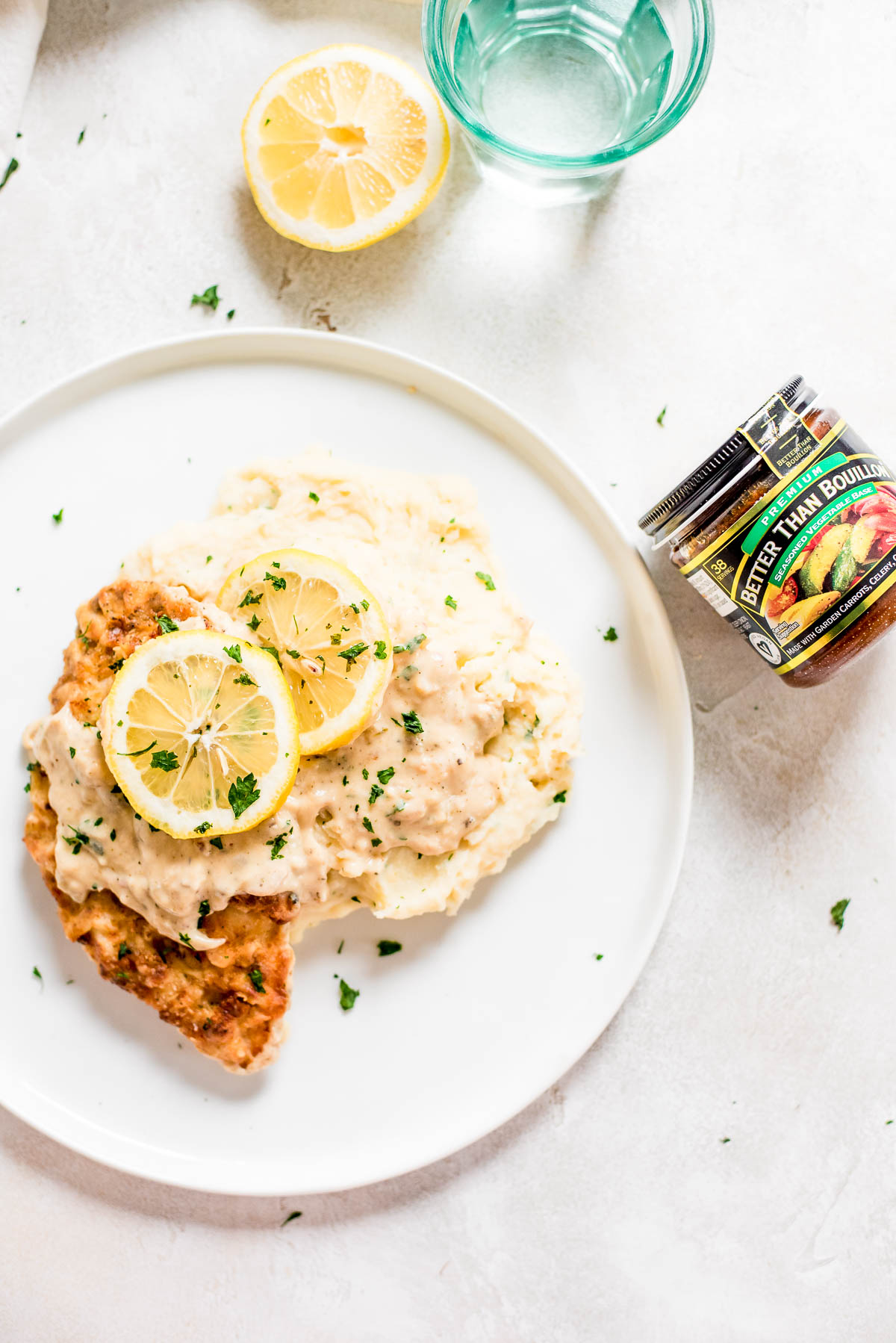 chicken, mashed potatoes, and lemon sauce on a plate