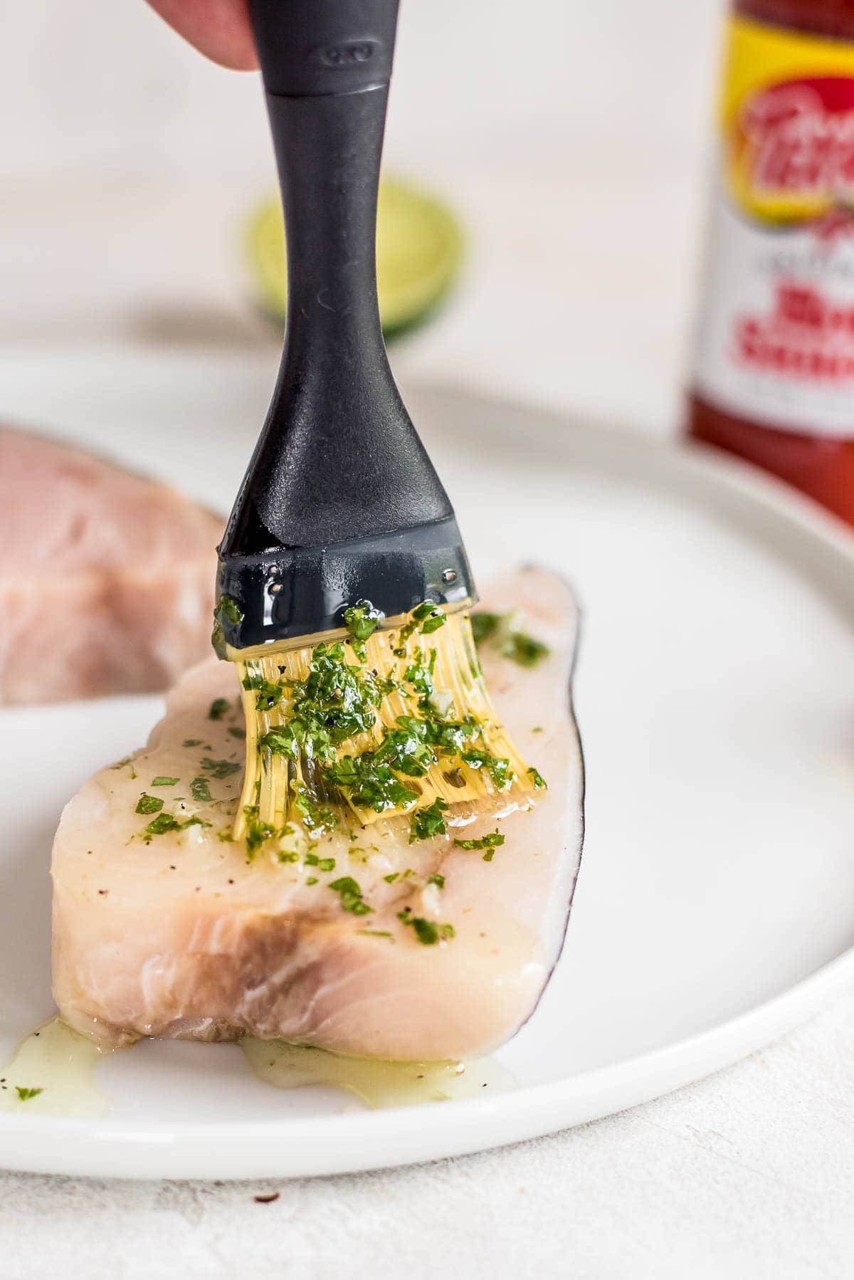 swordfish being covered in marinade