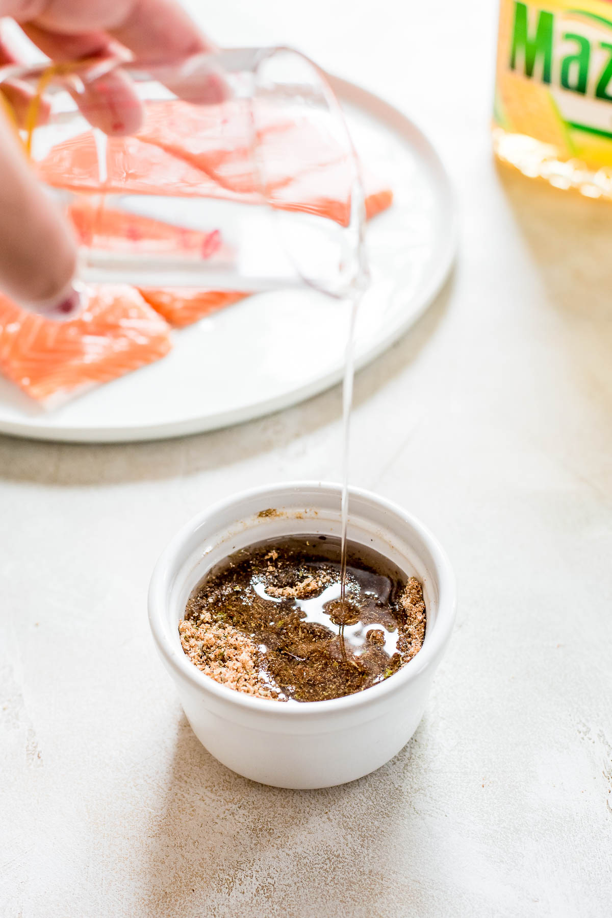 oil being drizzled into marinade cup 