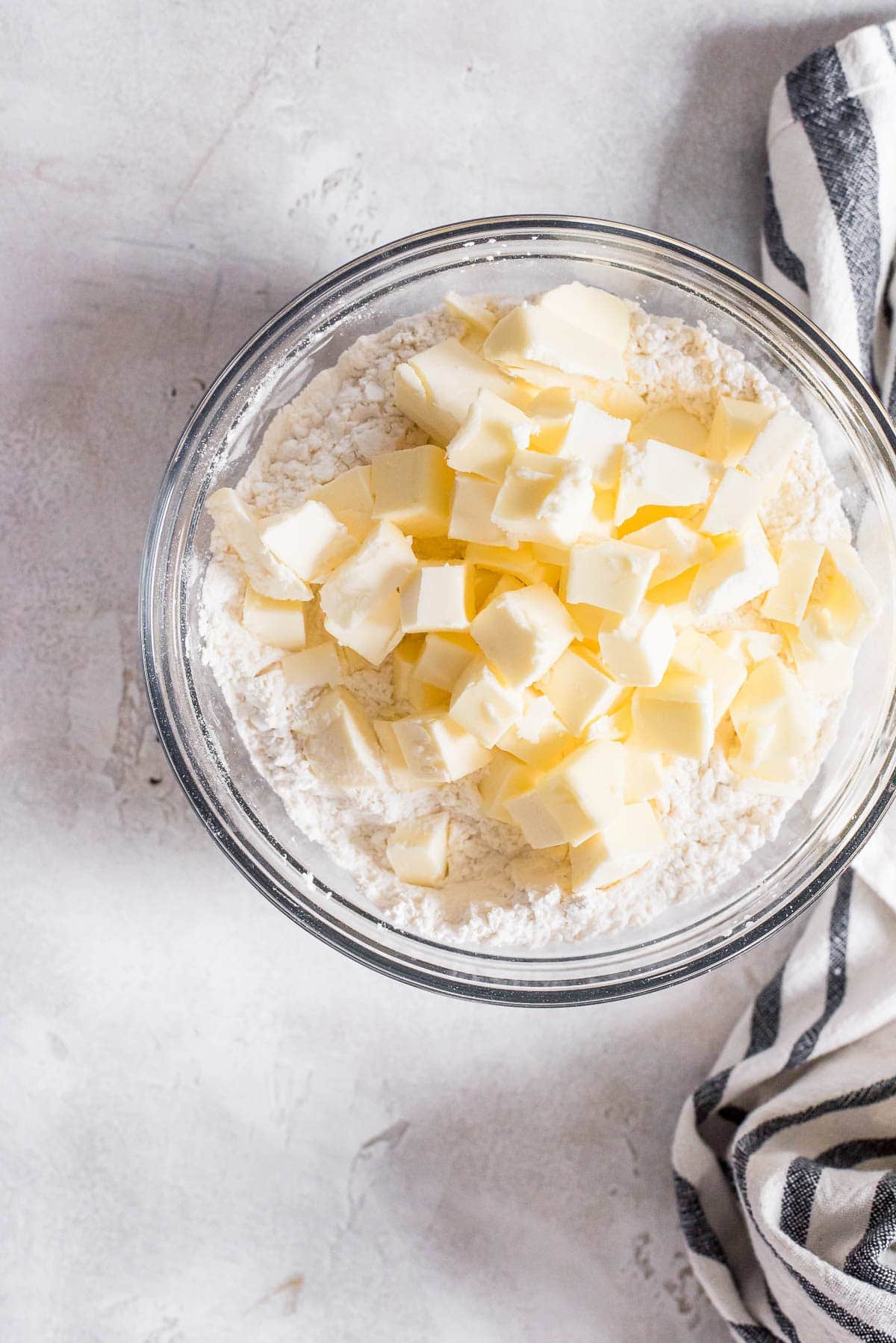 butter added to flour mixture in bowl