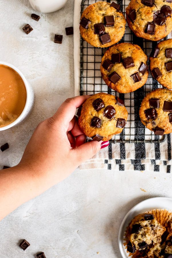 muffins sitting on wire rack one being grabbed