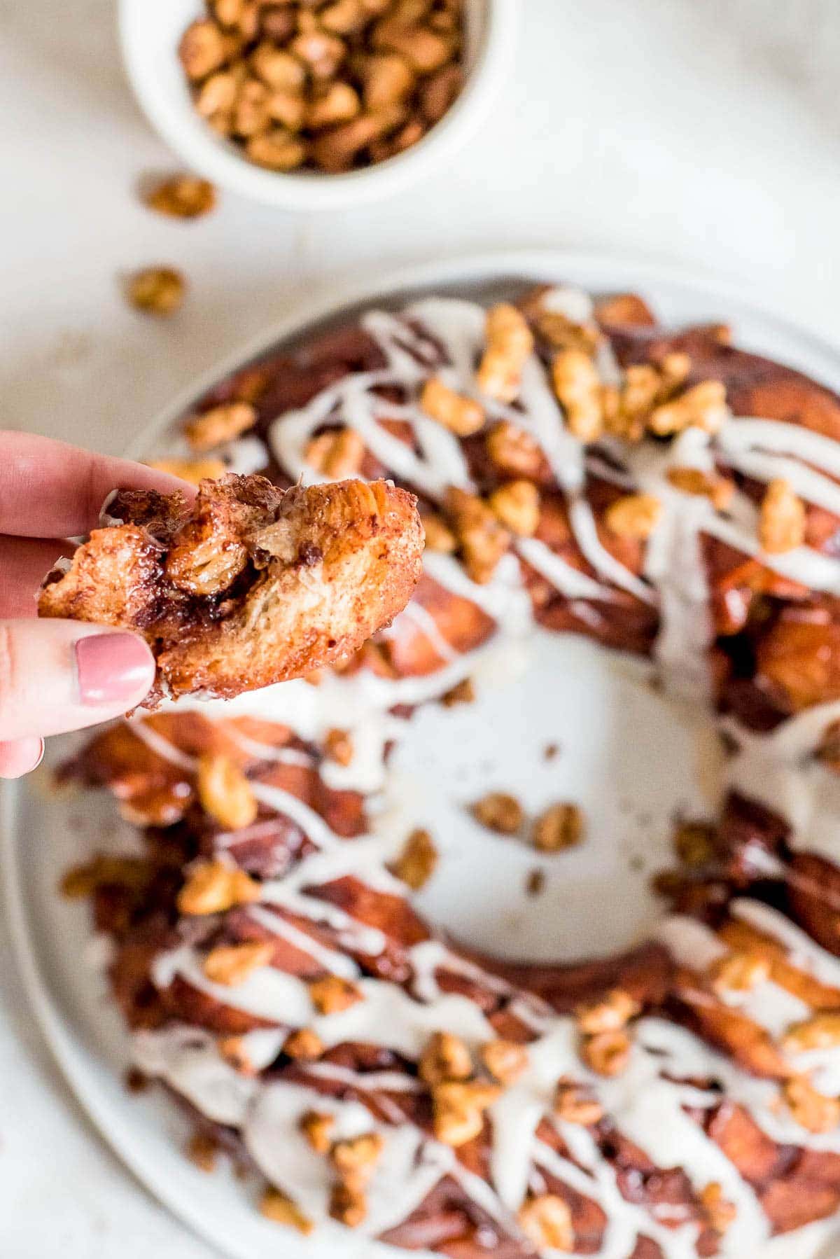 hand gabbing piece of monkey bread