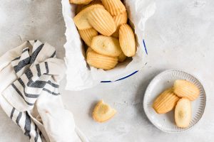 French madeleines in container and some on plate