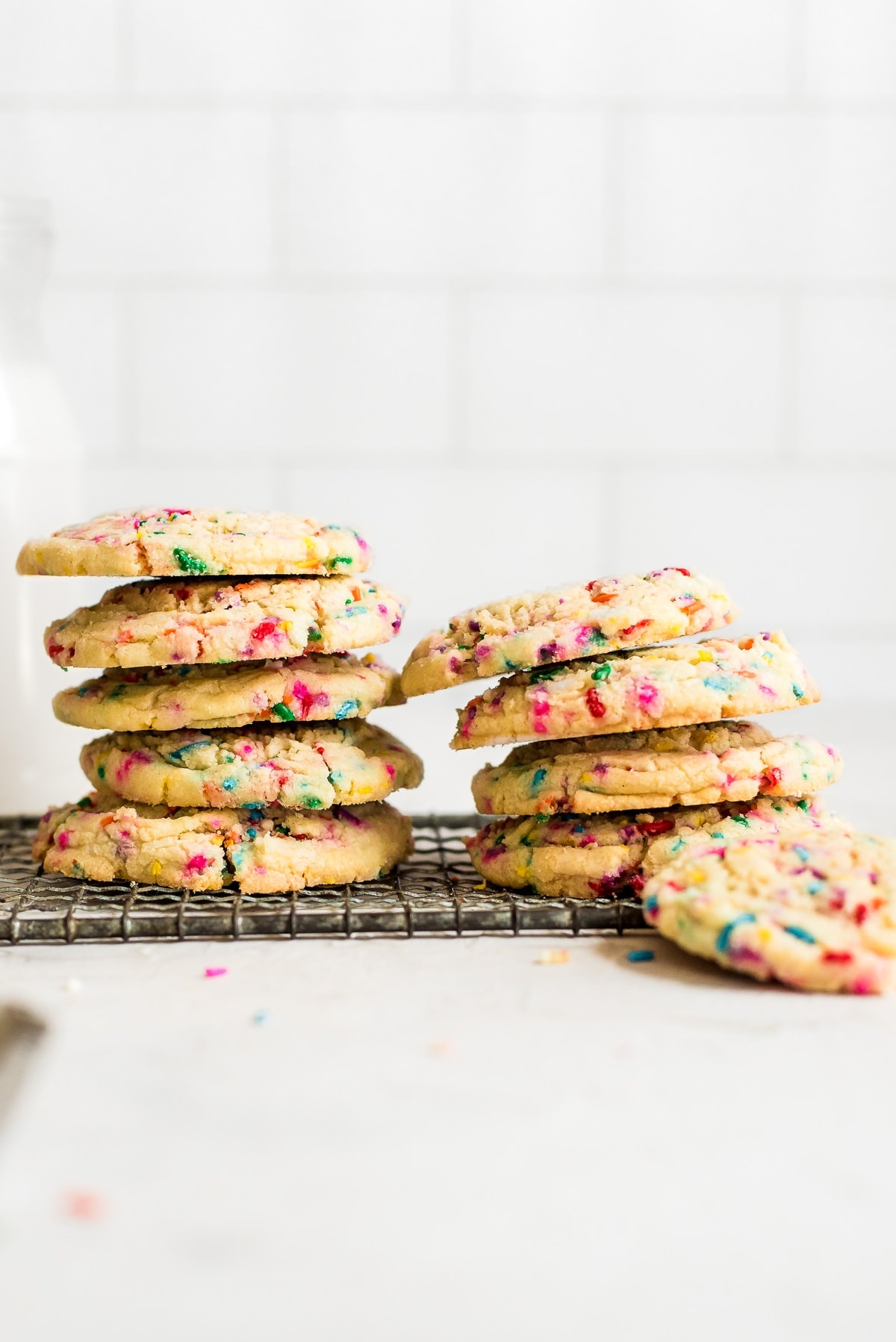 sprinkle sugar cookies stacked on wire rack