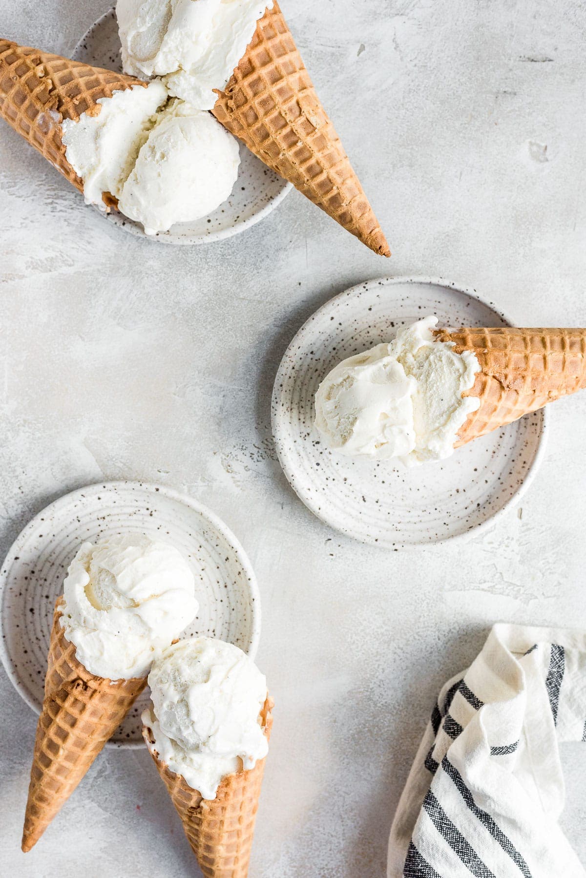 cones with ice cream on white ceramic plates