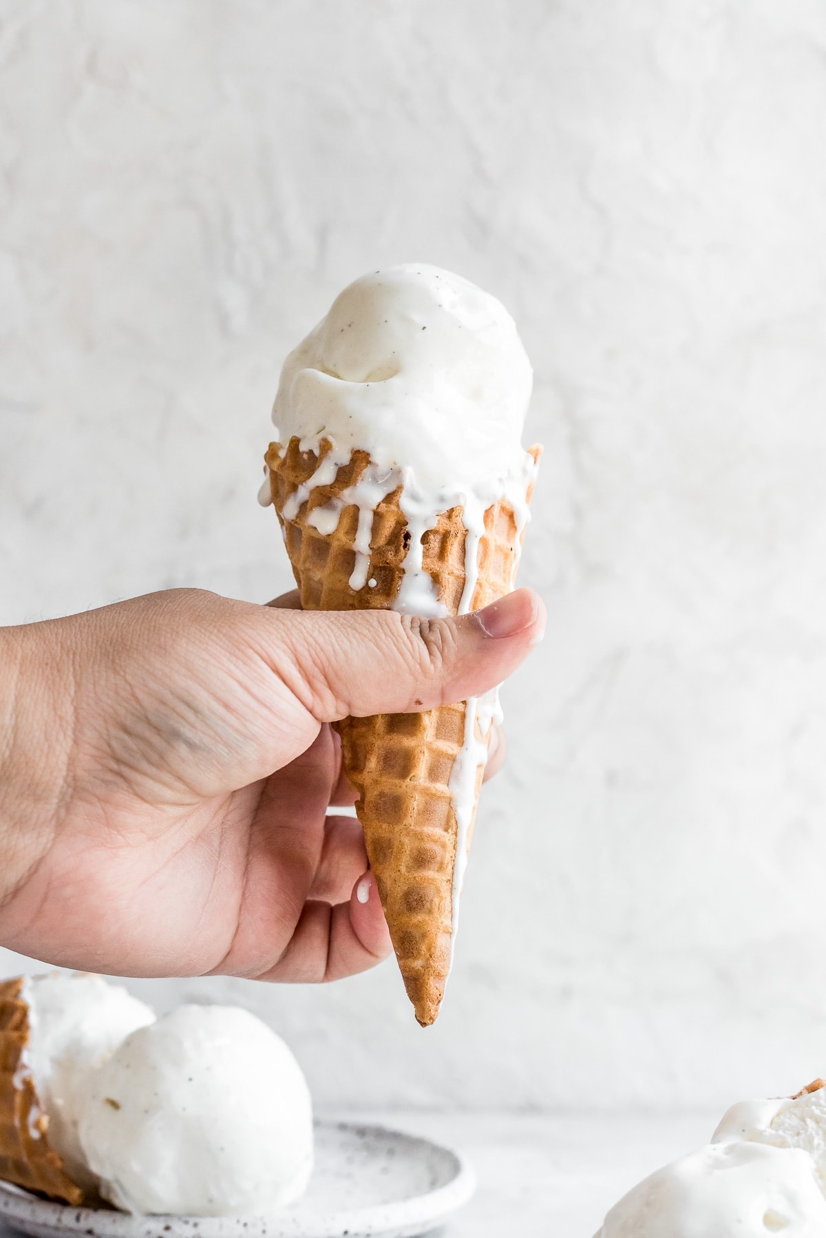 hand holding ice cream cone