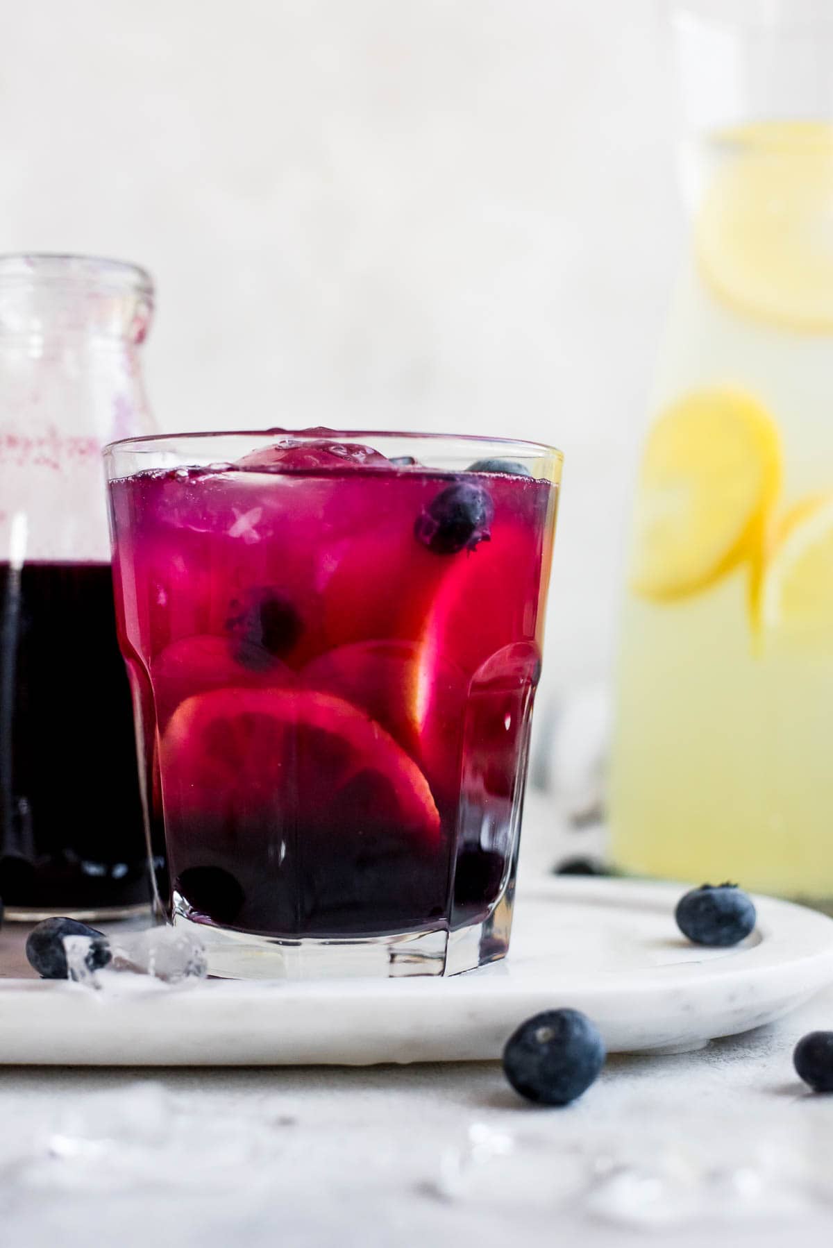 close up of glass full of lemonade with blueberries