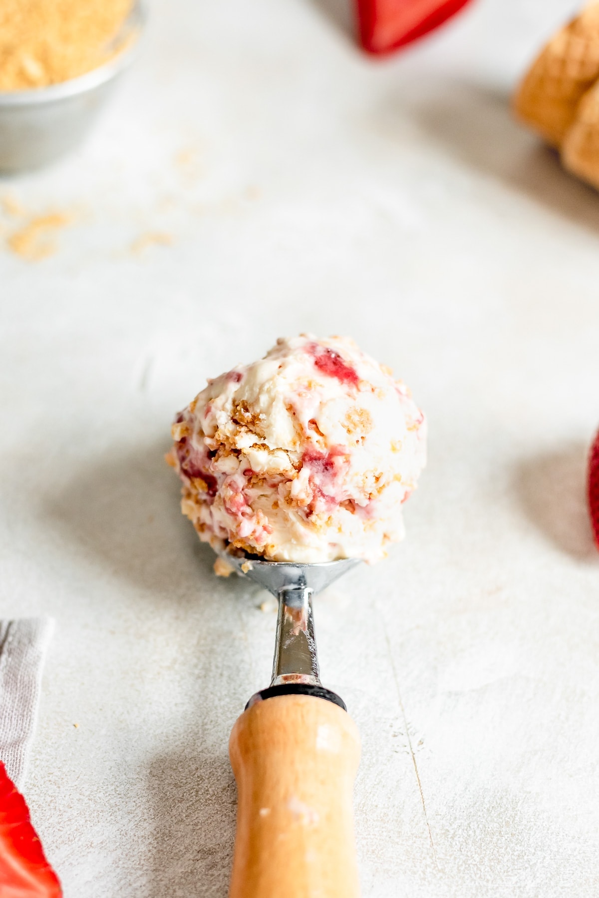 ice cream scoop full of strawberry cheesecake ice cream