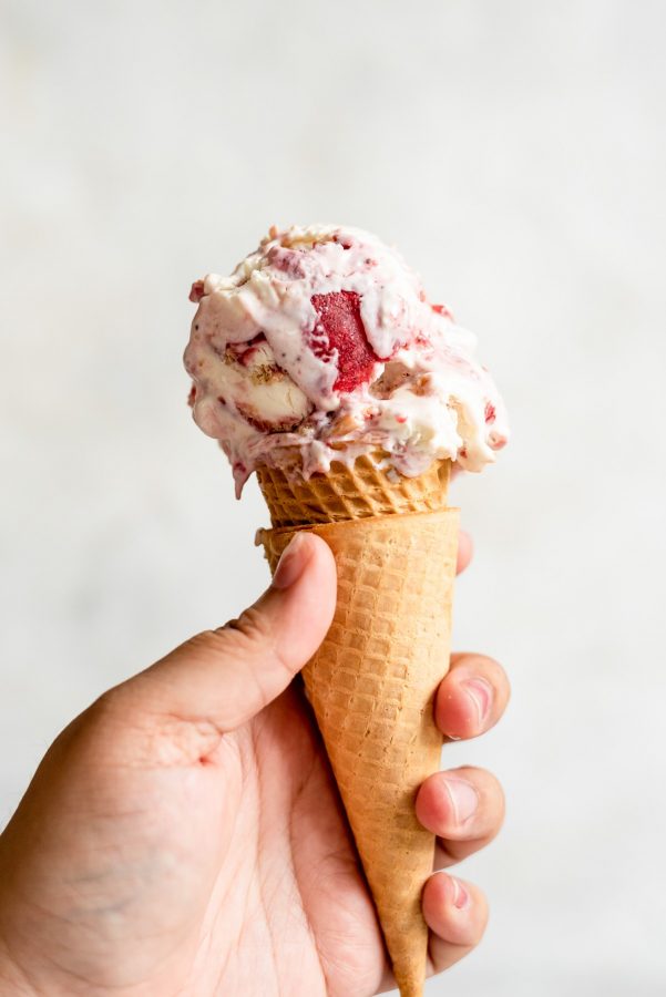 hand holding ice cream cone dripping