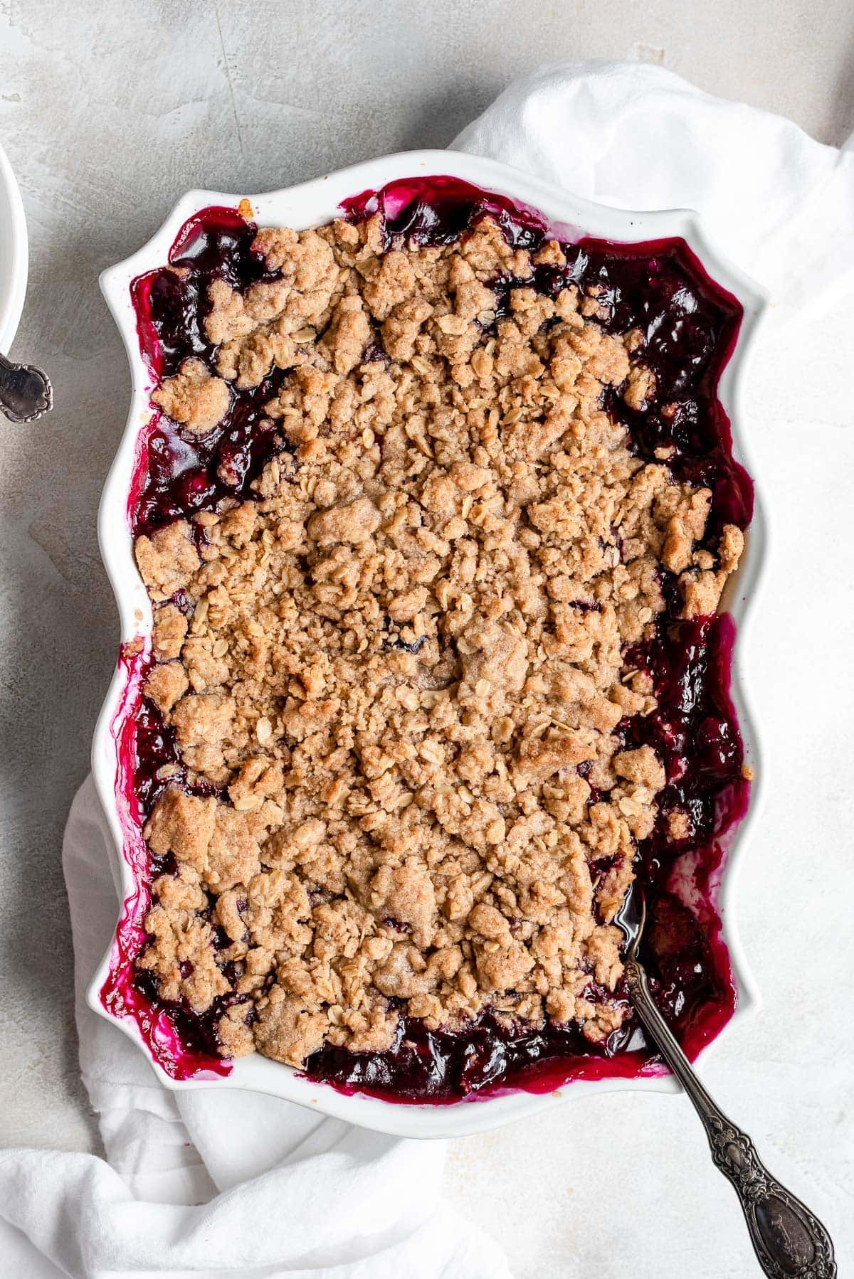 whole baked blueberry crisp in white pan