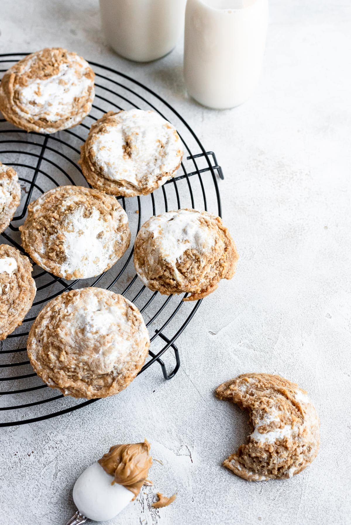 cookies on wire rack with one cookie with missing bite