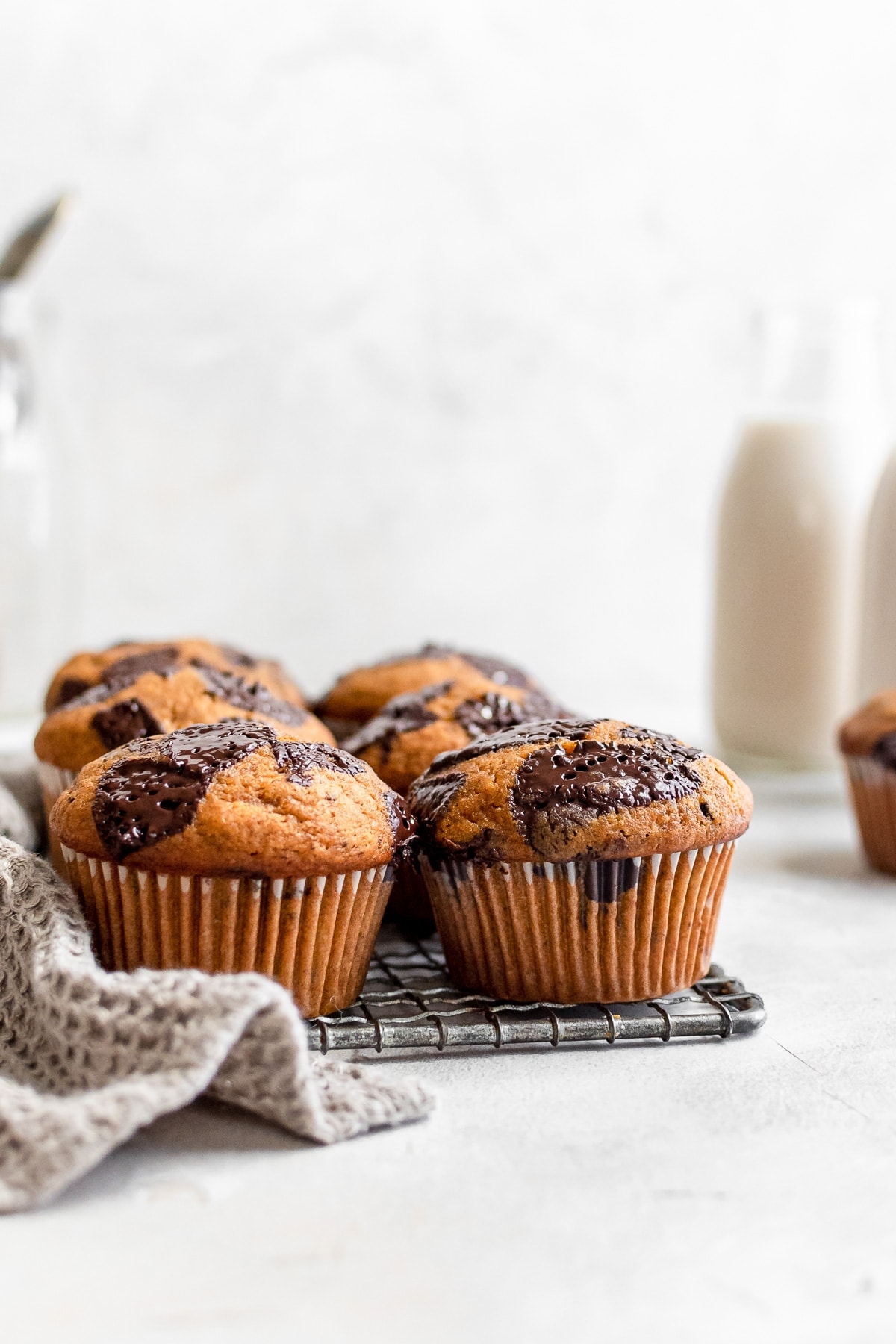 pumpkin muffins on wire rack with milk bottle in background