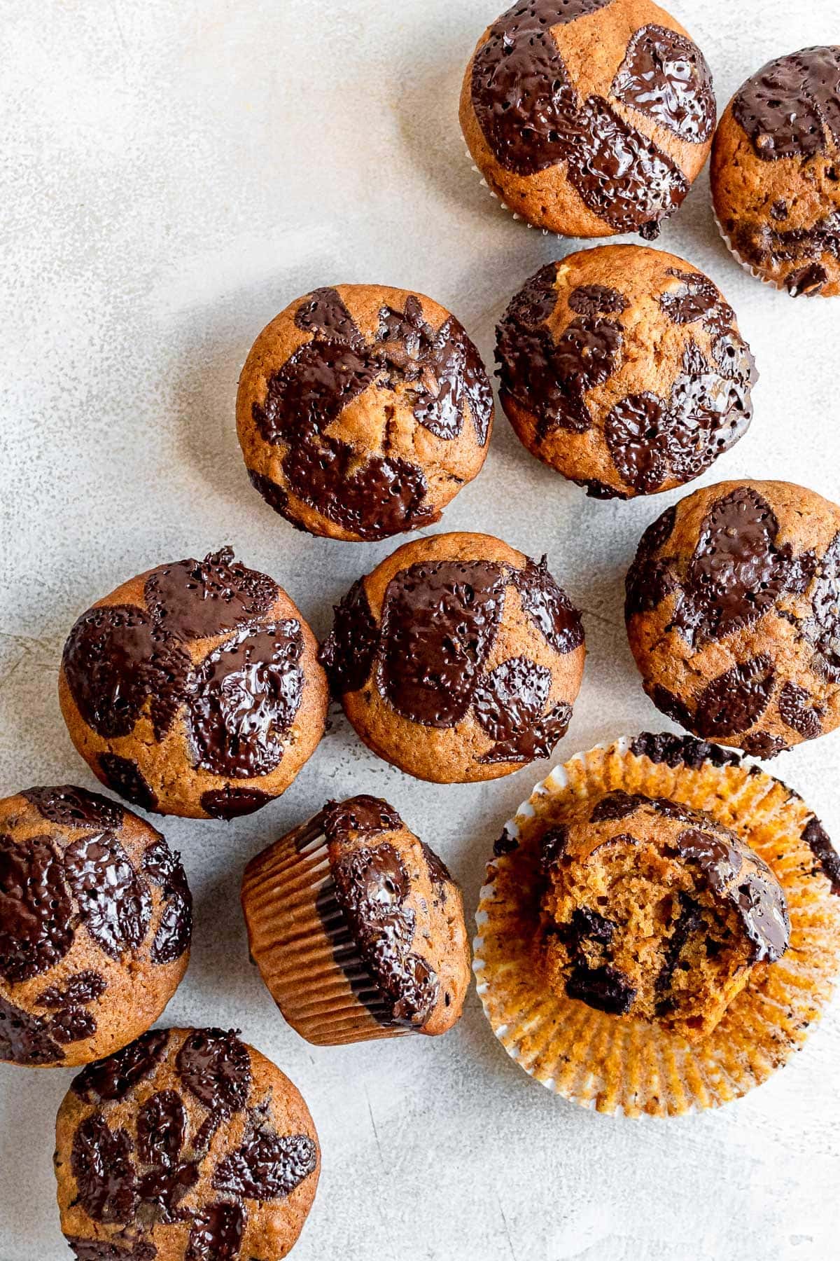 pumpkin chocolate chip muffins scattered on table