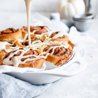 icing being poured over chai rolls