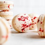 close up of macaron showing splatter of food coloring on shell