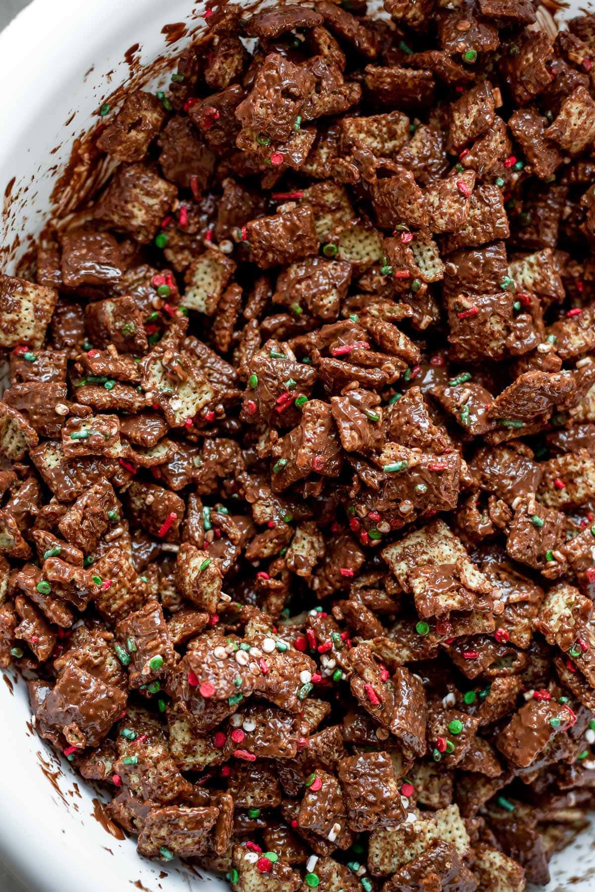 cereal mixed with chocolate and peanut butter and sprinkles for christmas muddy buddies