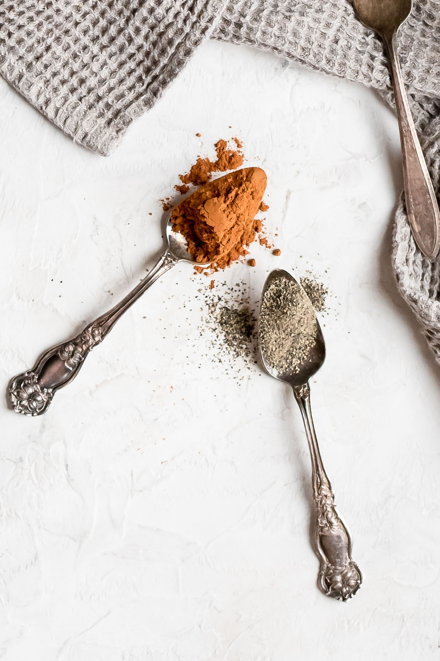 close up spices in spoons cinnamon and pepper
