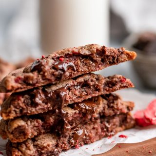 close up showing inside of gooey chocolate chip cookie with strawberries