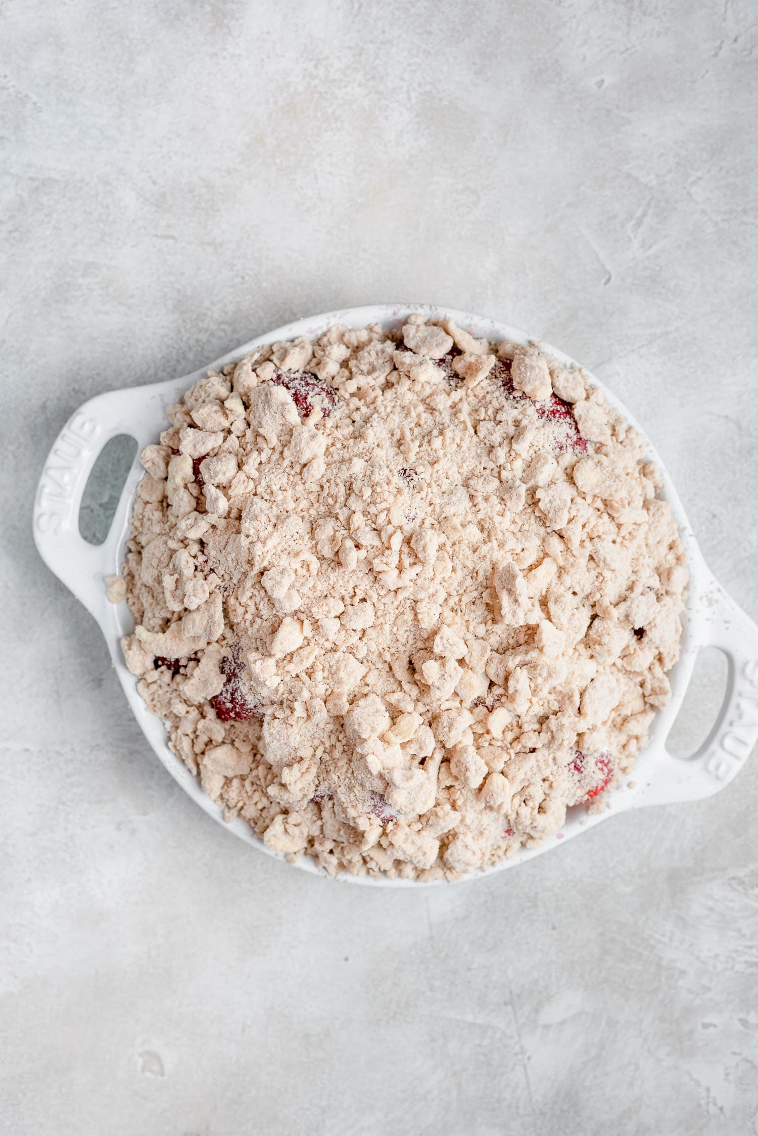 streusel on top of berries in pan