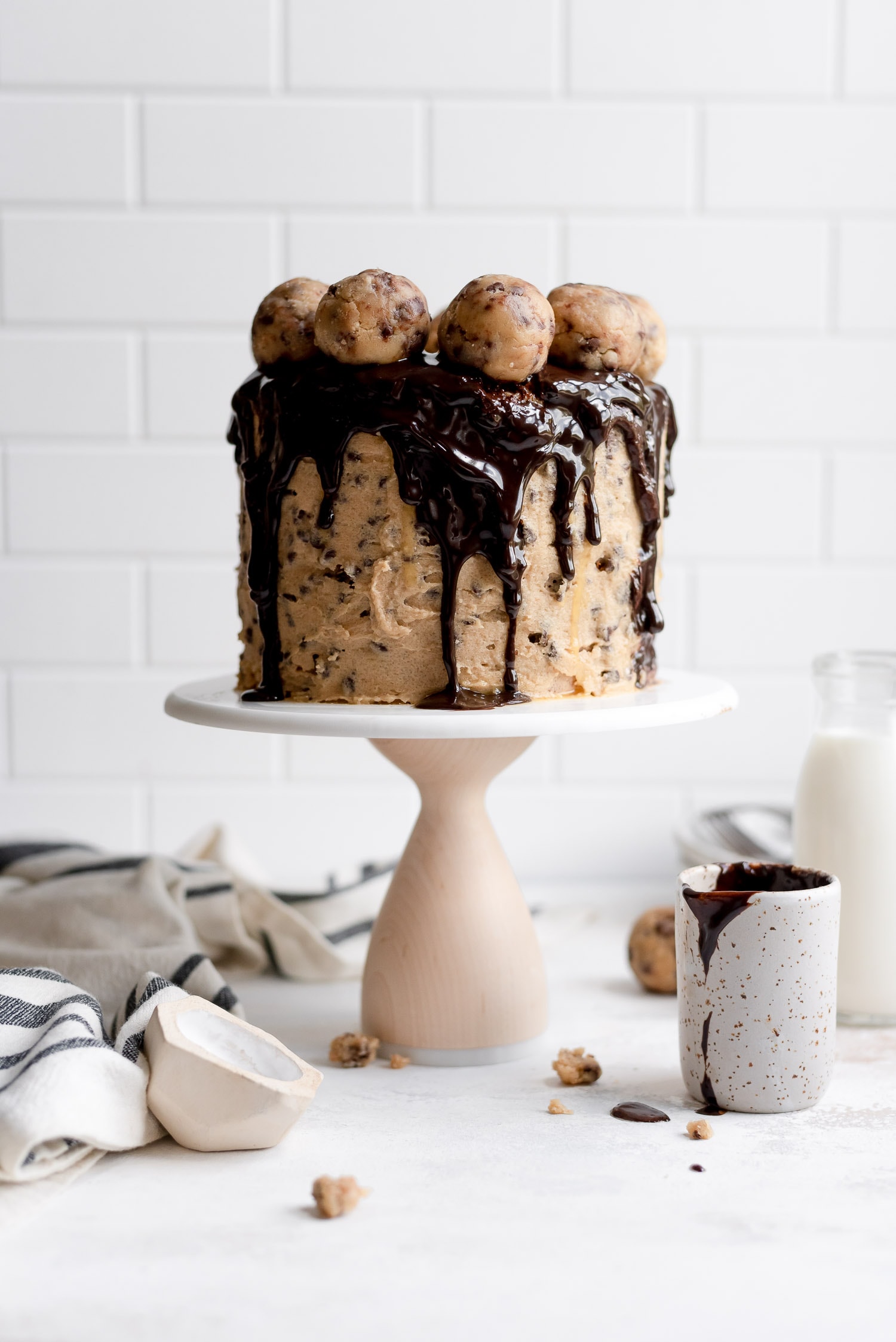 cookie dough cake on stand next to ingredients