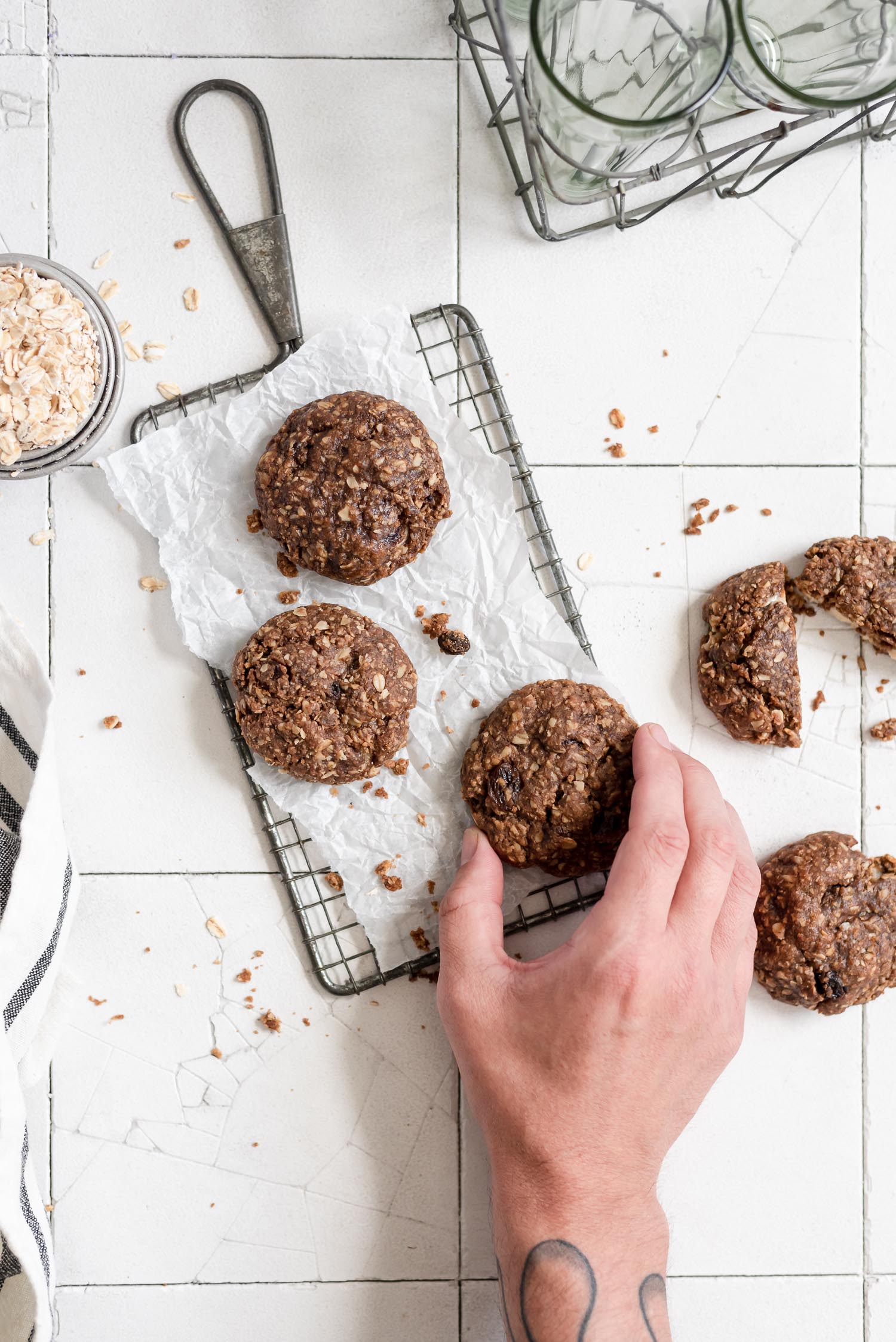 hand grabbing cookie on wire rack