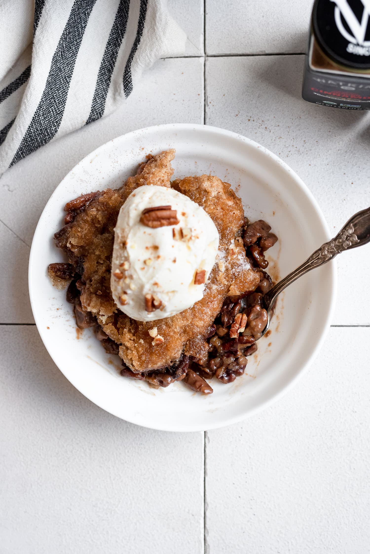 overhead pecan cobbler in bowl with ice cream