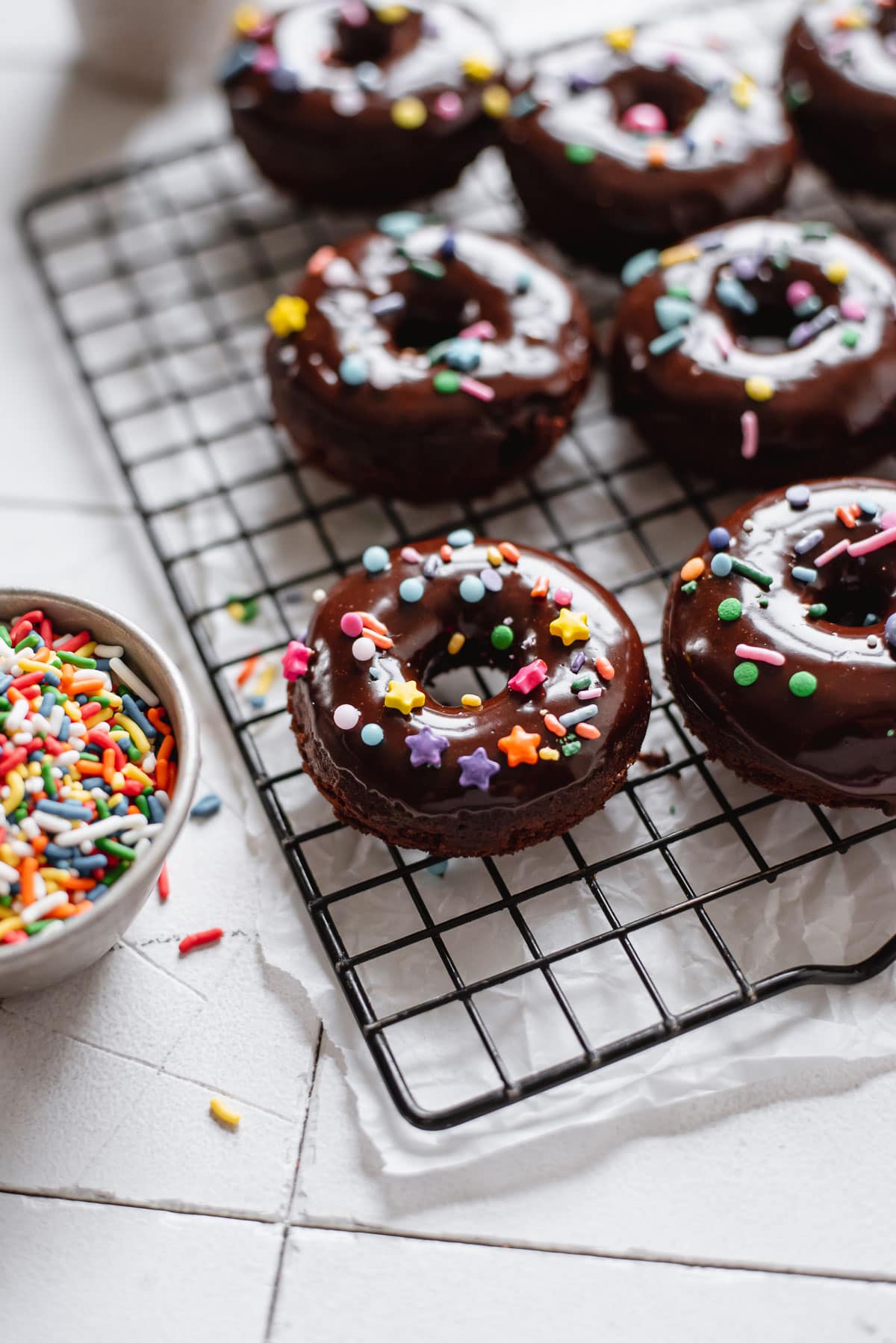 backlit shot of donuts on wire rack