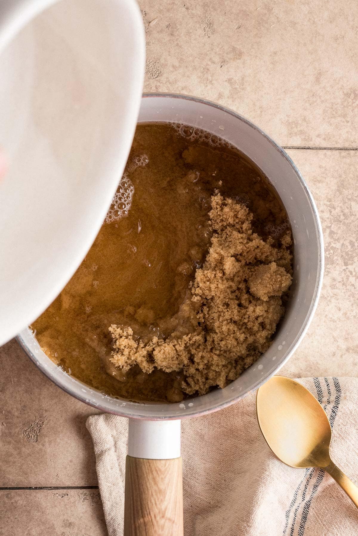 brown sugar and water being added to saucepan