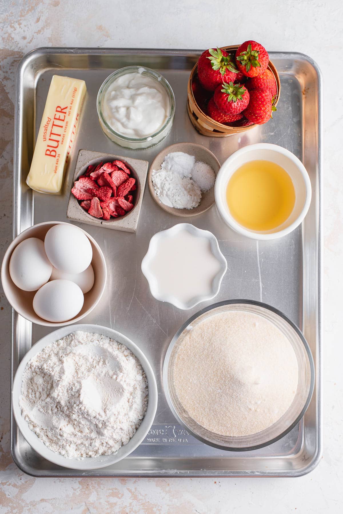ingredients for sheet cake in bowls on baking sheet